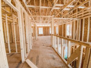 Framed custom home under construction in Tennessee, showing early phases of the build timeline from foundation to framing.
